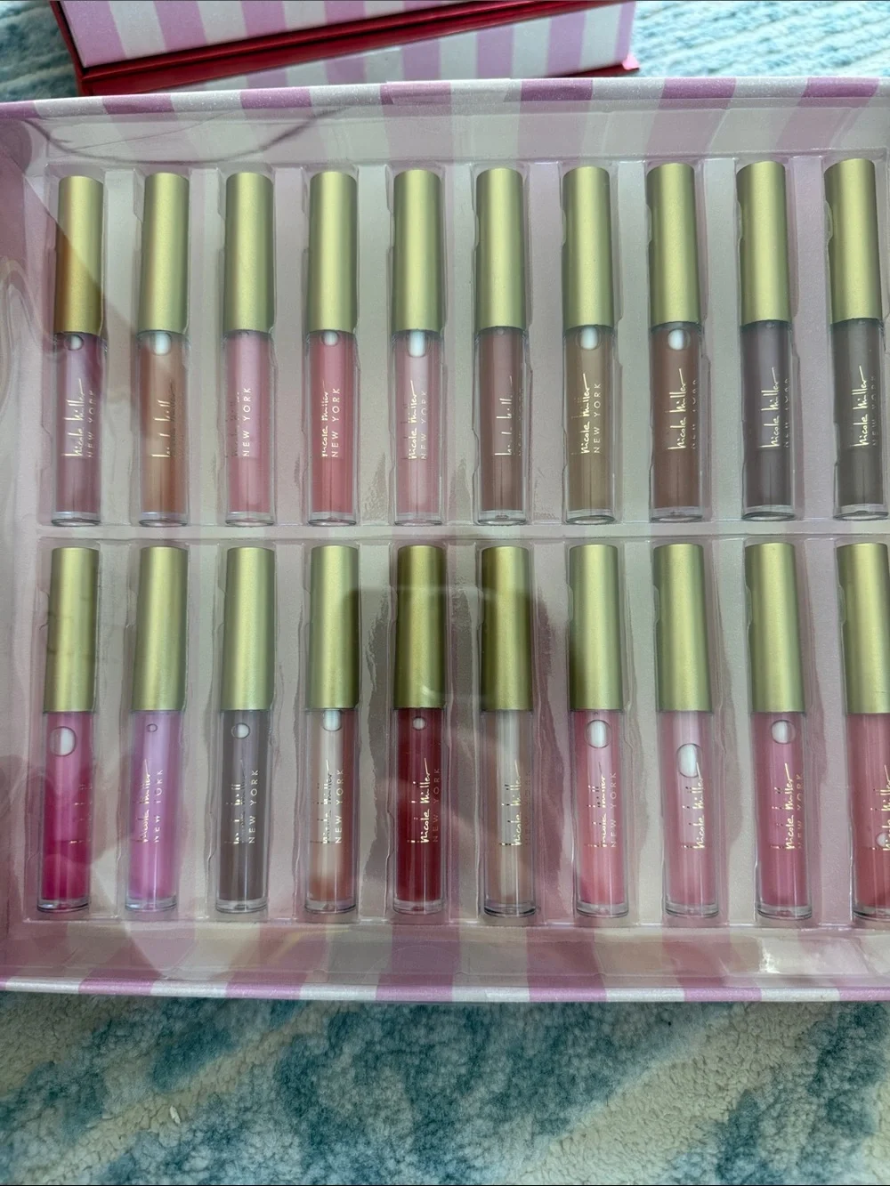NIB 20-piece Nicole Miller Lip Oil Collection - Red Packaging with Gold Caps